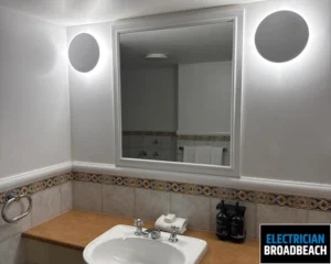 Modern bathroom with a mirror above the sink, showcasing the clean and minimalistic design